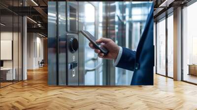 A businessman uses his smartphone to access an elevator, an abstract concept of technology as a background and potential best-seller Wall mural