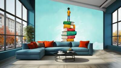 Young Boy Standing on Tower of Colorful Books Under Blue Sky Wall mural