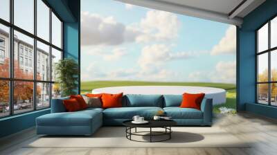 A serene landscape featuring a round platform surrounded by lush grass and fluffy clouds under a bright blue sky. Wall mural