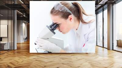 beautiful scientist working on microscope in medical lab white clean tone Wall mural