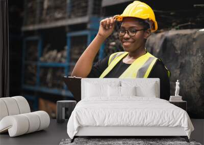 black African woman worker work in metal heavy industry machine factory as engineer team standing portrait smile Wall mural