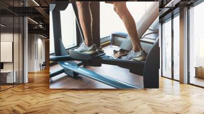 closeup healthy fitness people man sport strength exercise activity at gym on eclipse climbs machine Wall mural