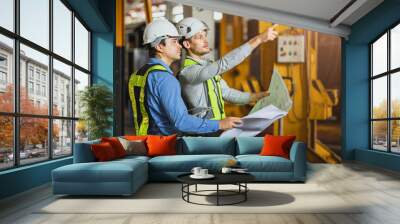 Construction engineer with technician designer team working build site inspect for interior renovate in industry workshop building with floor plan. Wall mural