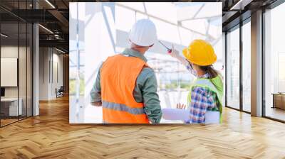 Engineer builder architect team working check roof beam construction progress structure building. Wall mural