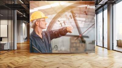 Engineer senior mananger worker looking at wristwatch overlay time clock face. Industry factory working hours concept. Wall mural