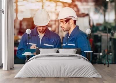 Engineer teamwork cooperate with worker to checking factory machine for safety and talking together. Wall mural