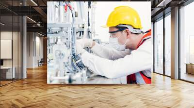 Engineer working maintenance service machine with clean and safety in factory. Wall mural