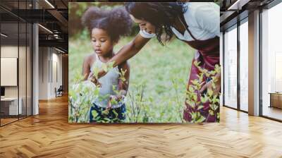 Family lovely gardening watering green plant activity with children during Stay at Home to reduce the outbreak of the Coronavirus. children watering the plant at backyard. Wall mural