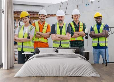 Group of workers teamwork in construction industrial plant. Diverse workers standing arm crossed together. Happy Industrial engineer people team concept. Wall mural