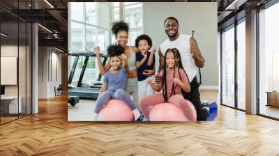 healthy black family children and parent exercise activity healthcare together at fitness sport club. Wall mural