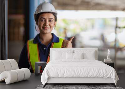 Indian woman staff worker engineer supervisor in safety suit work in factory warehouse Wall mural