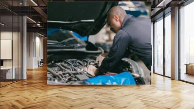 mechanic male car engine service underhood checking oil replace in broken part at auto garage Wall mural