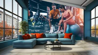 Modern technology in sport science concept. muscle strength training people in sport club overlay data chart body analysis diagram interface Wall mural