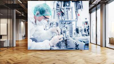 Science worker engineer service fix repair advance machine in medical equipment hygine factory. Wall mural