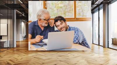 Son and Elder Father happy moment together looking at laptop for good memory. Wall mural