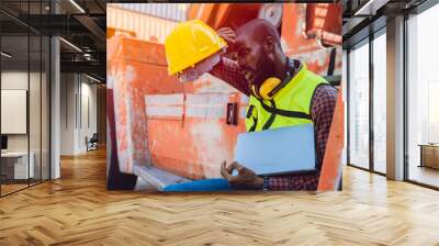 Tired stress worker sweat from hot weather in summer working in port goods cargo shipping logistic ground, Black African race people. Wall mural