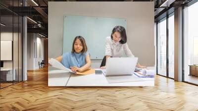 Two young Asian employee working in the office Wall mural