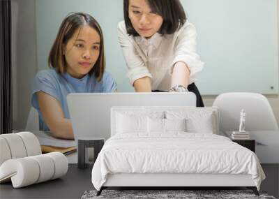 Young Asian businesswomen working together in the office Wall mural