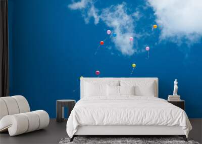 Many balloons flying into the sky. Multicolored balloons in the sky with clouds Wall mural