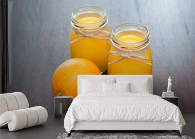 Orange juice in jars and whole fruit rustic style Wall mural