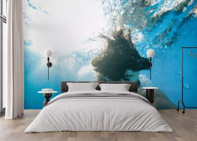 young man under the water of a swimming pool Wall mural