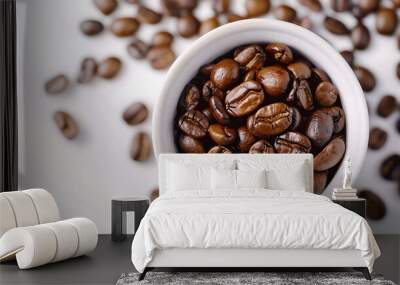 A close-up of a coffee cup with freshly roasted beans, arranged on a clean white background Wall mural