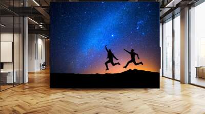 Two men jumping one night with stars Wall mural