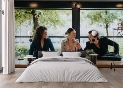 Group of business colleagues having a misunderstanding and arguing at a desk inside a modern office setting. Wall mural