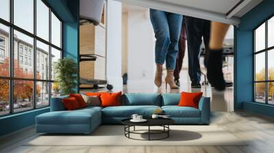 Modern office environment: Colleagues walking together in a bright workspace. Wall mural