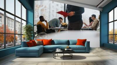 Multiracial business teammates engaged in a collaborative workspace environment. Wall mural