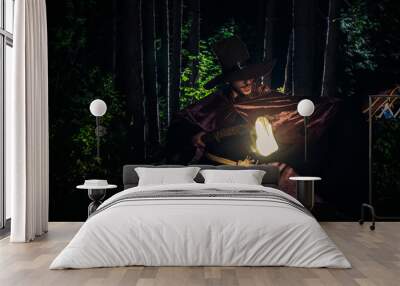 Wizard man with magic wand perform illusion in forest Wall mural