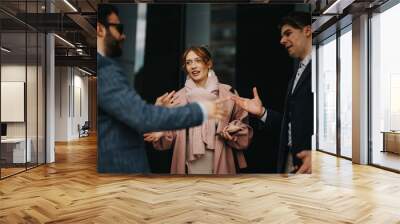 Young entrepreneurs conduct an outdoor business meeting, focusing on strategy, project costs, and profit growth in an urban setting. Wall mural