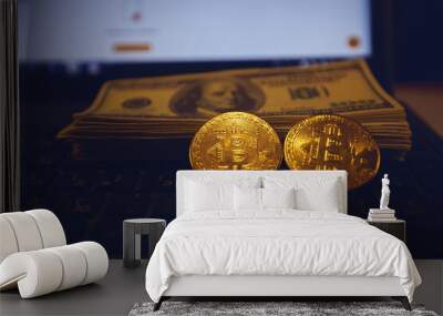 There are two gold bitcoins and a stack of 100 bills on the la Wall mural