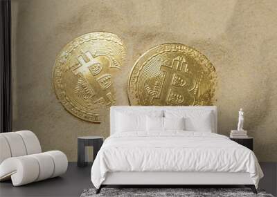 Two bitcoin coins on the sand. Close up Wall mural