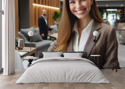 Happy receptionist at hotel front desk counter welcoming business people. Attractive young businesswoman smiling and making a resevationon laptop, modern luxury resort hotel lobby interior background. Wall mural