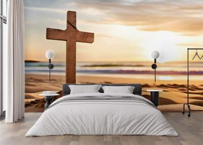 Small wooden Christian cross in sand on the beach with sea in background and copy space. Wall mural