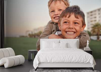 happy, smile and portrait of brothers with piggyback ride playing in a park together on vacation. ha Wall mural