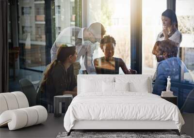 They give their all at work. Shot of a group of businesspeople having a meeting in a boardroom. Wall mural