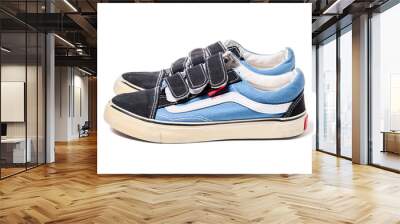 Used blue pair of baby sneakers isolated on white background side view. Wall mural