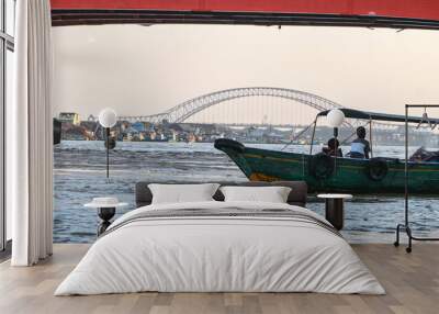 Palembang, Indonesia - June 14, 2024: boats as a means of public transportation on the MUSI river. famous river in the city of Palembang, South Sumatra, Indonesia. Wall mural