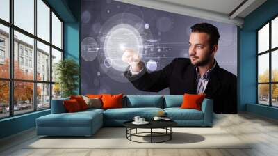 Attractive businessman touching abstract high technology circula Wall mural