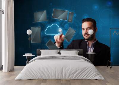 Attractive businessman touching high technlogy cloud service Wall mural