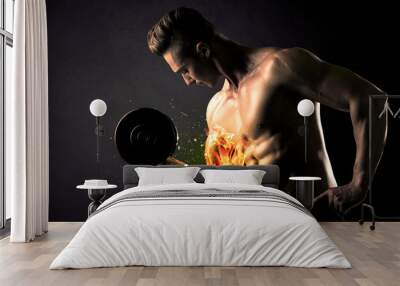 Bodybuilder athlete lifting weight with fire explode arm concept Wall mural