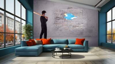 Business man hitting brick wall with hammer Wall mural