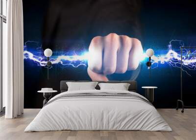 Business man holding electricity light bolt in his hands Wall mural