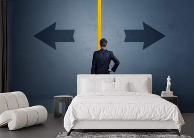 Business person choosing between two options separated by a yellow border arrow Wall mural