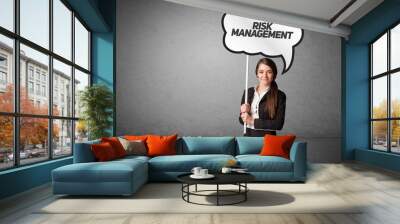 business person in casual holding road sign Wall mural