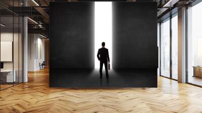 business person looking at wall with light tunnel opening Wall mural