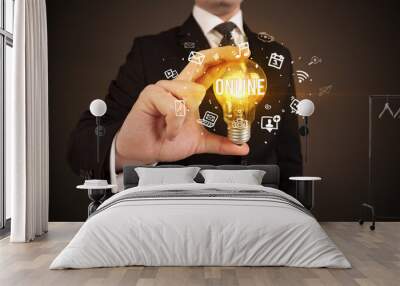 Businessman holding a light bulb, social media concept Wall mural