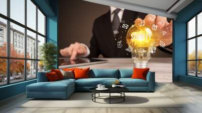 Businessman holding light bulb with SOCIETY inscription, social media concept Wall mural